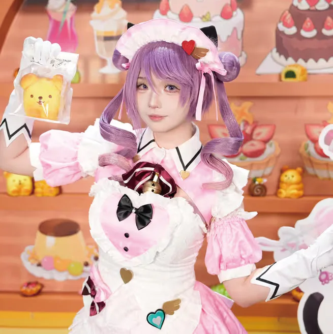 Costumed participant in a pink and purple outfit at the Eternal Return booth